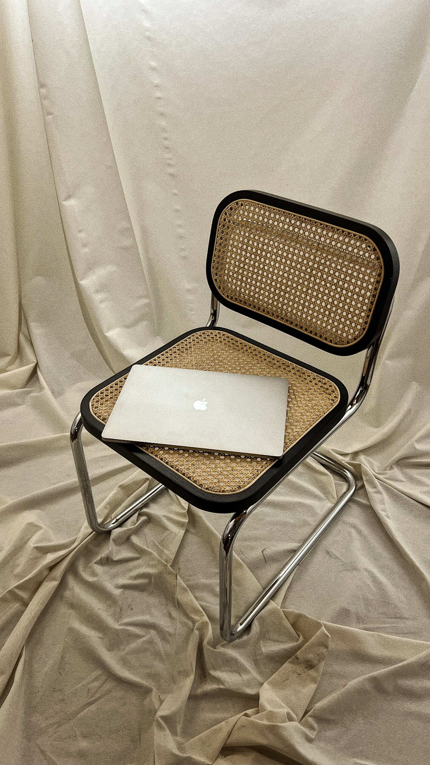 Sagecrest Communications laptop rests on a chair.